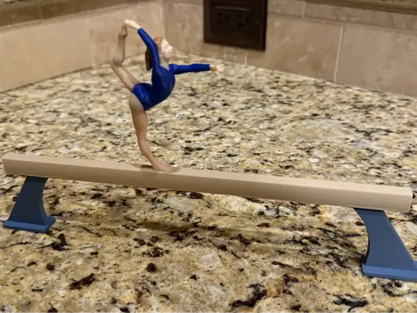 Girl gymnast on balance beam